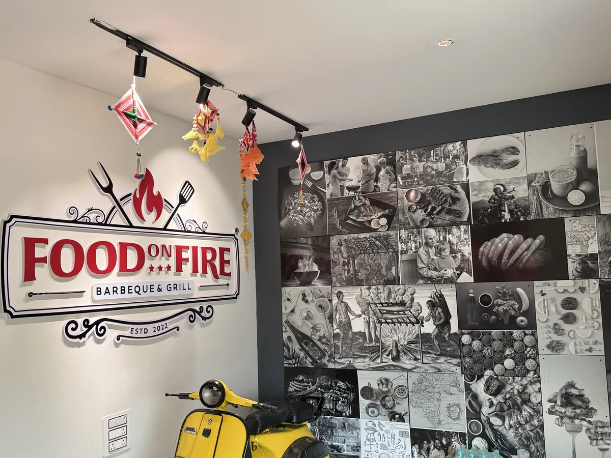 Inside Food on Fire Barbeque and Grill, Hanamkonda, Warangal — the branded live-grill wall