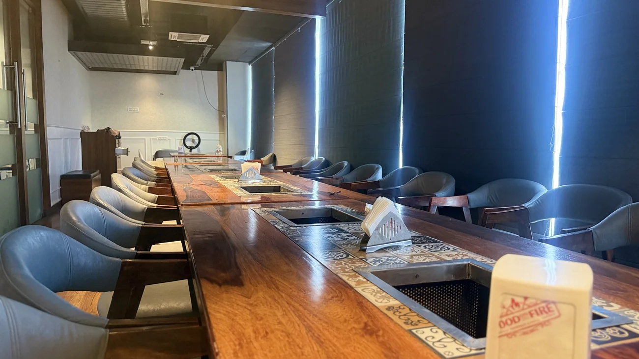 Live-grill communal dining tables at Food on Fire BBQ, Hanamkonda, Warangal