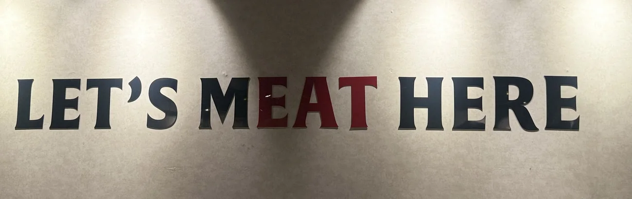 Let's Meat Here signature wall art at Food on Fire BBQ, Hanamkonda, Warangal