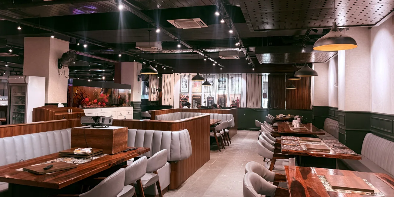 Warm interior with booth seating and pendant lighting at Food on Fire BBQ, Hanamkonda, Warangal